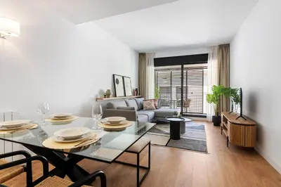a living room with a table and a couch at CATERINA Gràcia in Barcelona