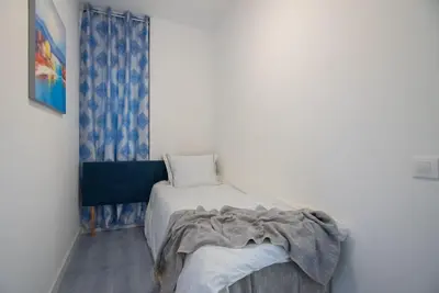 a bedroom with a bed with a blanket on it at +25Y ONLY, Family flat near the beach in Barcelona