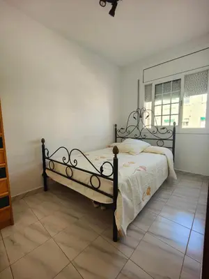 a bedroom with a large bed in a room at Apartamento en la playa in Cunit