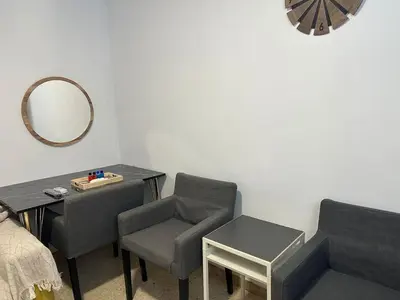 a room with a table and chairs and a mirror at Can Ginesta Muy feliz&tranquilo in Barcelona