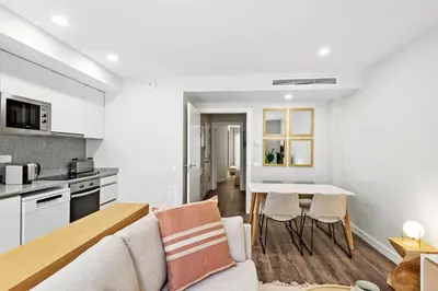 a kitchen and living room with a couch and a table at CATERINA Mar Bella in Barcelona