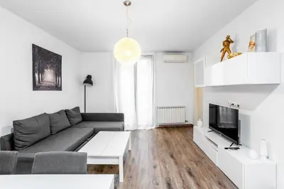 a living room with a couch and a tv at The Collection Barcelona - Paseo de Gracia Modern and cozy 3BD - 2BTh in Barcelona