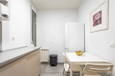 a kitchen with white cabinets and a sink and a microwave at The Collection Barcelona - Paseo de Gracia Modern and cozy 3BD - 2BTh in Barcelona