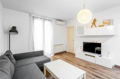 a bedroom with a bed and a large window at The Collection Barcelona - Paseo de Gracia Modern and cozy 3BD - 2BTh in Barcelona