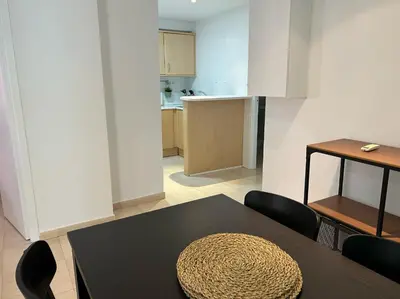 a room with a table and chairs and a kitchen at Gaudi(M) Barcelona in Barcelona