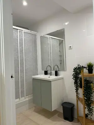 a white bathroom with a sink and a mirror at Gaudi(M) Barcelona in Barcelona