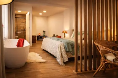a bedroom with a large bed with a checkered blanket at Private Loft Sant Celoni, Montseny, Barcelona in San Celoni