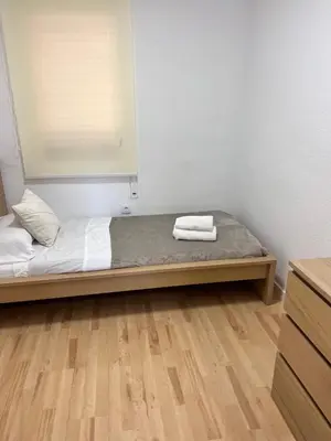 a room with a bed with two towels on it at Ca La Lidia in Viladecáns