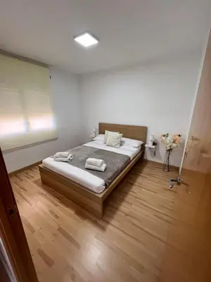 a bedroom with a bed with two towels on it at Ca La Lidia in Viladecáns