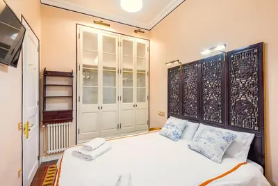a bedroom with a large white bed with blue pillows at Large patio 4 bedrooms 4 bathrooms of which 3 en-suite in Barcelona