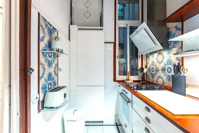 a kitchen with blue and white wallpaper and a sink at Large patio 4 bedrooms 4 bathrooms of which 3 en-suite in Barcelona