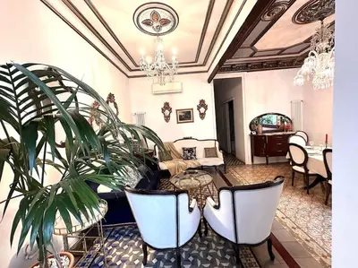 a living room with a table and a potted plant at Large patio 4 bedrooms 4 bathrooms of which 3 en-suite in Barcelona