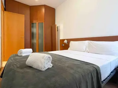 a bedroom with a large bed with white sheets at Hostourist@Bcn Apartamento Monumental in Barcelona