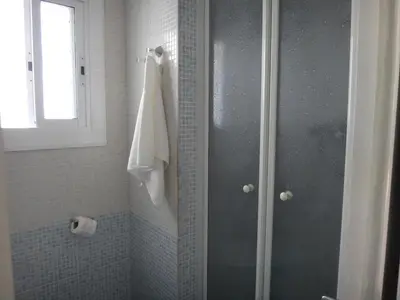 a shower with a glass door in a bathroom at A Home in Barcelona in Barcelona