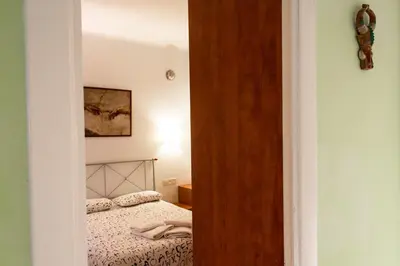 a small bedroom with a bed and a mirror at A Home in Barcelona in Barcelona