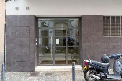 a motor scooter parked in front of a building at Port III Apart céntrico ideal familias 11 in Barcelona