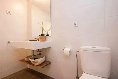 a white bathroom with a sink and a toilet at Port IV Apart céntrico ideal grupos 12 in Barcelona