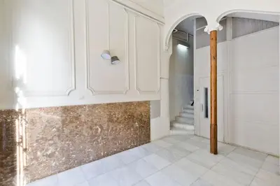 a hallway with white cabinets and a tile floor at Modern and bright apartment well located in Gracia in Barcelona