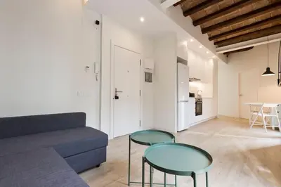 a living room with a couch and two glass tables at Modern and bright apartment well located in Gracia in Barcelona