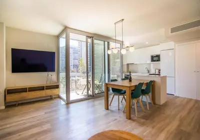 a kitchen and dining room with a table and chairs at Forum Casa Barcelona in Sant Adria de Besos