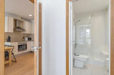a bathroom with a shower and a toilet in a kitchen at GuestReady - Bright home near Montjuïc in Barcelona