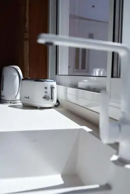 a toaster sitting on a counter next to a window at Stay U-nique Apartment Padilla in Barcelona