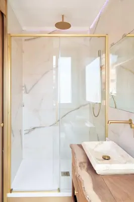 a shower with a glass door in a bathroom at Stay U-nique Apartment Padilla in Barcelona