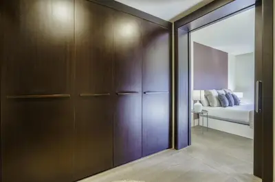 a bedroom with a closet with a bed and a mirror at Ola Living Paseo de Gracia in Barcelona