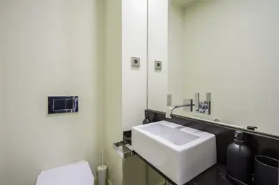a bathroom with a white sink and a toilet at Ola Living Paseo de Gracia in Barcelona