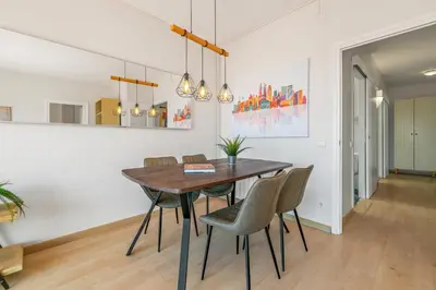 a dining room with a wooden table and chairs at Tendency Apartments Sagrada Familia Penthouse in Barcelona