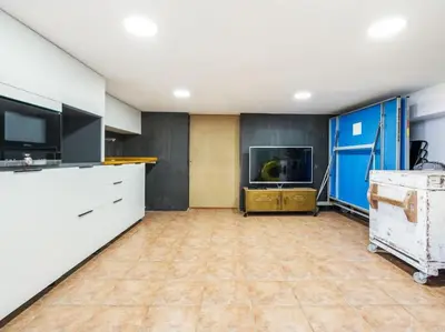 an empty room with a kitchen with a tv and a tvictericterictericter at Villa Alella Panoramic Views in Alella