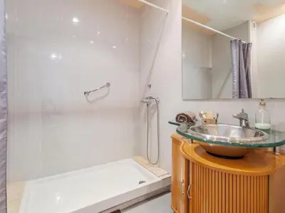 a bathroom with a sink and a mirror and a tub at Villa Alella Panoramic Views in Alella