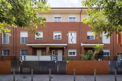 a brick building with a gate in front of it at Apartamento Luxury Gran Via 2 in Hospitalet de Llobregat