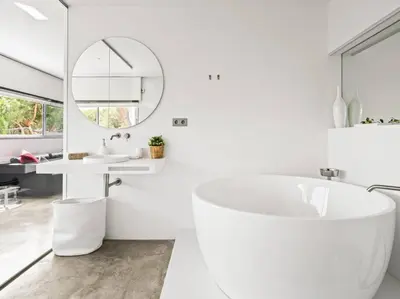 a white bathroom with a tub and a sink at Design villa sea views and lap pool in Cabrils