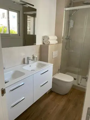 a bathroom with a sink and a toilet and a shower at Gaudi Street Apartments in Sitges