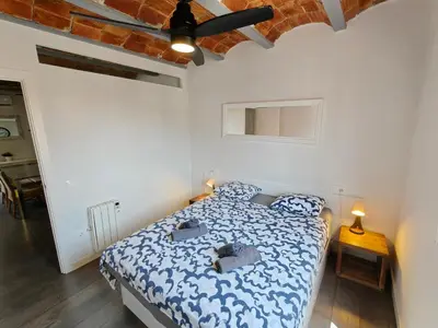 a bedroom with a bed and a ceiling fan at Magnificent apartment Camp Nou in Hospitalet de Llobregat