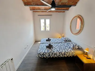 a bedroom with a bed and a mirror on the wall at Magnificent apartment Camp Nou in Hospitalet de Llobregat