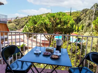 a blue table with a coffee maker on a balcony at Apartment Els Pins by Interhome in Sant Vicenç de Montalt