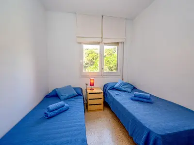 two twin beds in a room with a window at Apartment Els Pins by Interhome in Sant Vicenç de Montalt