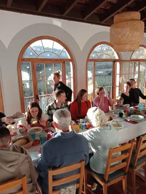 a group of people sitting around a dinner table at Historic house 5 minutes walk from the beach in San Pol de Mar