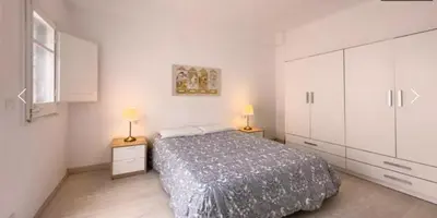 a bedroom with a bed and two lamps on tables at Precioso Estudio en Sant Gervasio in Barcelona