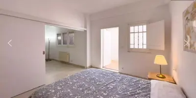 a bedroom with a bed and a large window at Precioso Estudio en Sant Gervasio in Barcelona