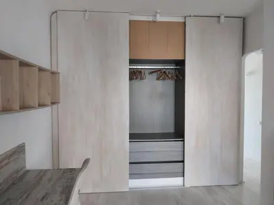 a room with a closet with wooden cabinets at La Bellamar - Apartamento en primera línea mar- in Premiá de Mar
