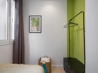 a bedroom with green and white walls and a mirror at Sunny Apartment 3bed with terraze in Barcelona