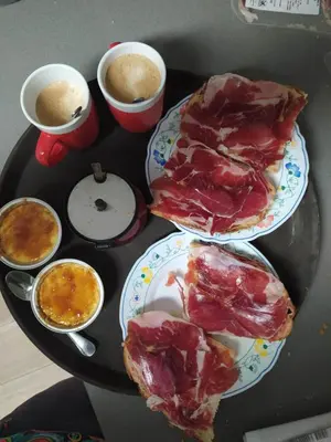 a table with two plates of food on a table at Primera línea de mar y piscina a 20 minutos de Barcelona in Premiá de Mar