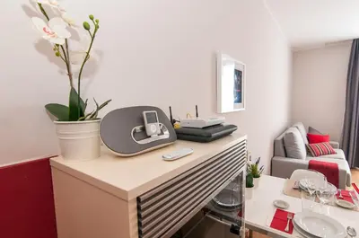 a room with a desk with a phone on it at Pelayo Deluxe Apartments in Barcelona