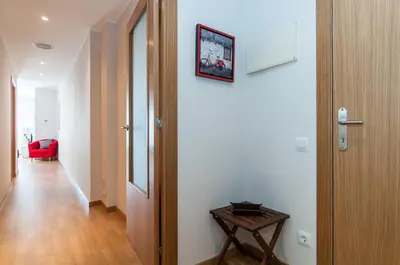 a hallway with a table next to a door at Pelayo Deluxe Apartments in Barcelona