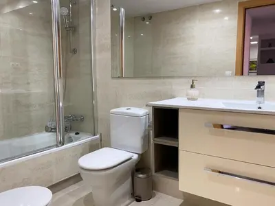a bathroom with a toilet and a sink and a shower at Barcelona Beach Breeze in Barcelona