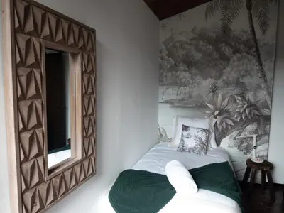 a bedroom with a mirror next to a bed at Les Alzines - Chalet con gran piscina cerca de Barcelona in Orrius