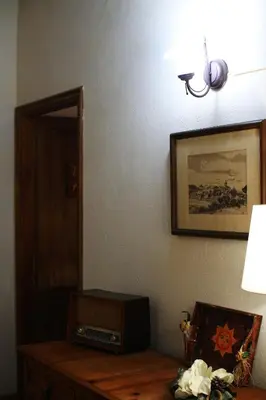 a room with a table with a radio and a lamp at El Celler de la Guàrdia in Montserrat